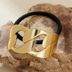 Minimalist gold chain link metal hair tie with high-elastic black band on natural stone