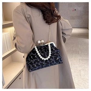 Detail of grey leopard print velvet shell bag with gold frame and pearl chain