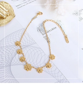 Close-up of gold daisy chain anklet showing K18 stamp and lobster clasp closure