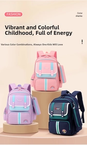 Three colorful primary school bags for kids with matching pencil cases and dino badges