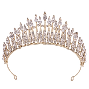 Elegant gold bridal tiara with white rhinestones in a leaf design for wedding hair styling