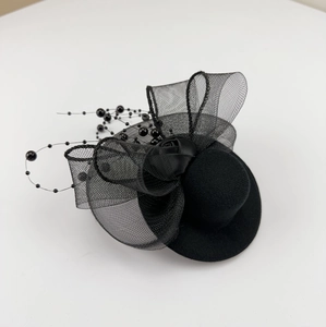 Vintage black mini top hat with mesh bow, rose flower, and beads on white background