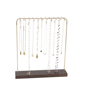 Golden metal necklace display stand with dark brown wood base for jewelry organization