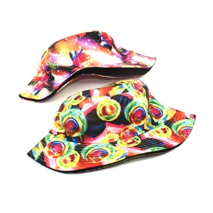 Detail of vibrant psychedelic floral and rainbow concentric circle patterns on bucket hats