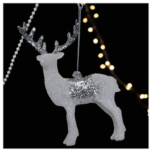 Detailed close-up of a white glitter reindeer Christmas ornament with silver sparkles