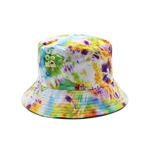 Detailed close-up of a double-sided cotton bucket hat featuring a vibrant tie-dye pattern