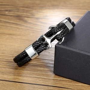 Braided leather anchor bracelet with silver clasp on rustic wood with gift box