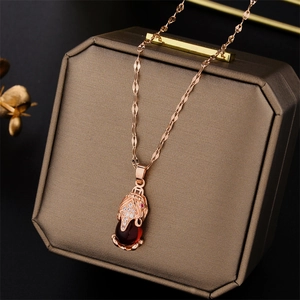 Rose gold Pixiu necklace with red gemstone and zircons on a luxury jewelry box