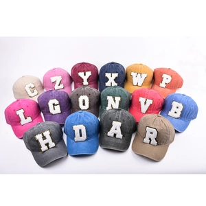 Assorted colors of vintage washed cotton baseball caps with sequined letter patches