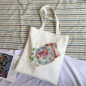 White canvas tote bag with strawberry print and large capacity for daily use