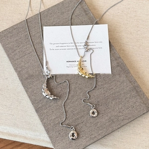 Gold and silver crescent moon necklaces with spiral texture and adjustable chain