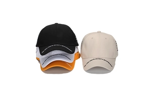 Detail of embroidered cotton baseball caps with printed quote on the curved brim