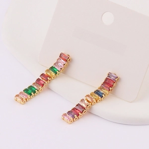 Detailed close-up of rainbow rectangular zircon tassels on elegant gold dangling earrings
