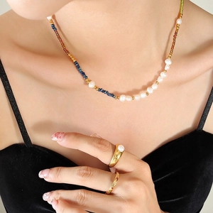 Bohemian freshwater pearl and colorful beaded necklace with gold rings on model