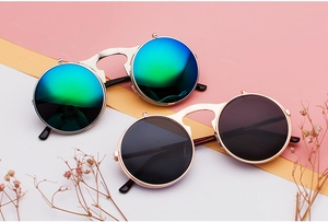 Detail of steampunk flip-up sunglasses with round metal frames and double-layered lenses