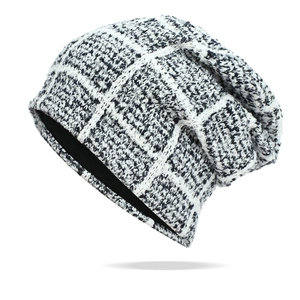 Detailed close-up of chunky knit texture and classic black and white checkered pattern beanie