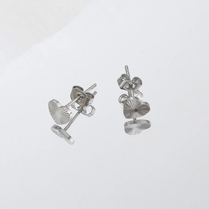Polished silver heart stud earrings with radiating sunburst texture on white background