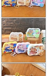 Close-up of car-shaped mini game machine keychains featuring cute animal patterns