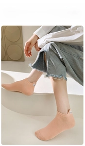 Detail of pink cotton socks with cute cartoon bunny ear embroidery and 3D back heel accents