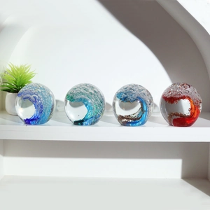 Macro detail of glass paperweights with ocean wave swirls and bubbles in multiple colors