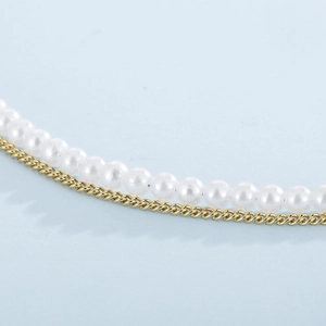 Detail of double-layer gold chain necklace with creamy white pearls and elegant luster