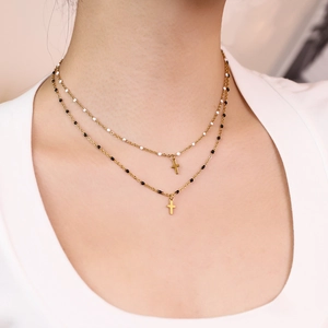 Double-layered gold stainless steel necklace with black and white beads and cross pendants