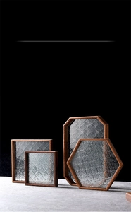 Detailed view of polygon crabapple glass trays with elegant solid wood frames for tea