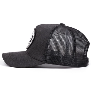 Détail de la maille respirante et de l'écusson brodé sur la casquette trucker gris foncé