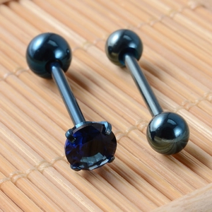 Detail of dark blue stainless steel tongue barbell with zircon stone on bamboo mat