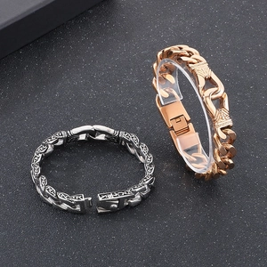 Detailed view of men's vintage steel bracelets with embossed patterns and Cuban links