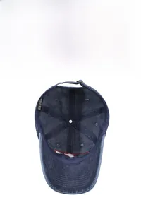 Detail view of washed navy cotton baseball cap interior with sweatband and metal buckle