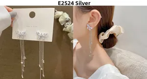 Macro detail of 925 silver butterfly tassel earrings with zircon stars on a model