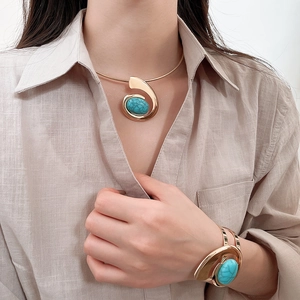 Detail of luxury gold choker and bracelet set featuring large blue turquoise resin stones