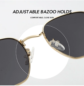 Detail of adjustable silicone nose pads and golden metal frame on polarized sunglasses