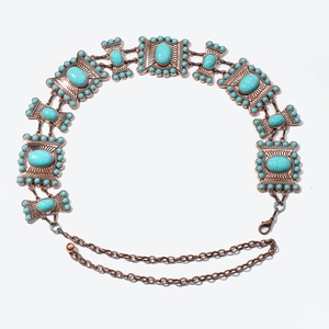 Close-up of vintage bronze waist chain with turquoise stones and adjustable lobster clasp