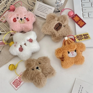 Close-up of colorful star-shaped plush keychains with embroidery, bells and lucky tags