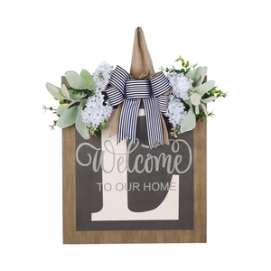 Letter L wooden door sign with Welcome To Our Home text, floral decor and striped bow