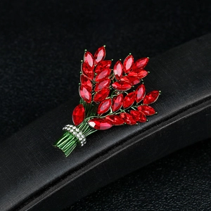 Elegant lavender wheat brooch with red crystals and rhinestones on black display