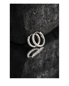 Macro shot of S925 sterling silver hoop earrings with pave cubic zirconia on black stone