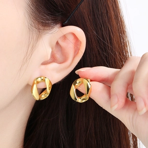 Close-up of 18K gold plated 13mm Cuban link chain earrings on a female model