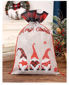 Detail of burlap Christmas gift bag with plaid edges and Merry Christmas printing