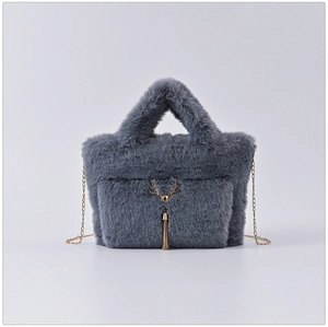 Detailed close-up of grey faux fur bag featuring a gold deer head and elegant tassels