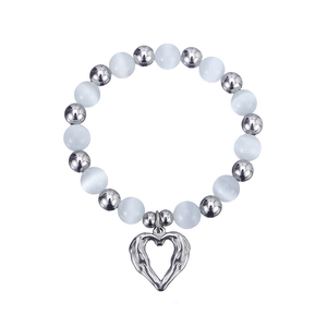 Detail of cat eye beads with silver heart charm on stainless steel bracelet