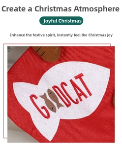 Detailed view of red woven Christmas stocking with fish patch and GOODCAT embroidery