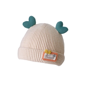 Cute cream knitted baby hat with green heart ears and Good Life patch for autumn and winter