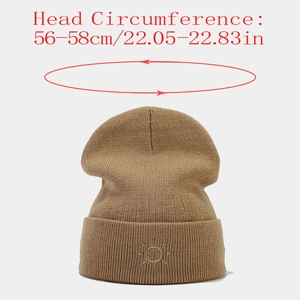 Detail view of khaki knit beanie with sun embroidery showing 56-58cm head circumference