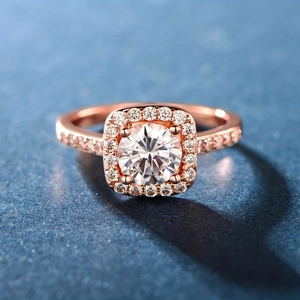Classic rose gold ring with round center stone and halo of princess cut zircon accents