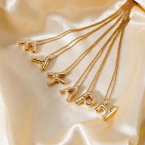 Gold plated bubble alphabet pendant necklaces with white zircon crystals on silk