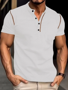 Close-up of white waffle texture polo shirt with brown trim and three-button henley collar