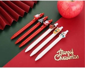 Macro detail of Christmas gel pens featuring 3D silicone Santa and reindeer toppers